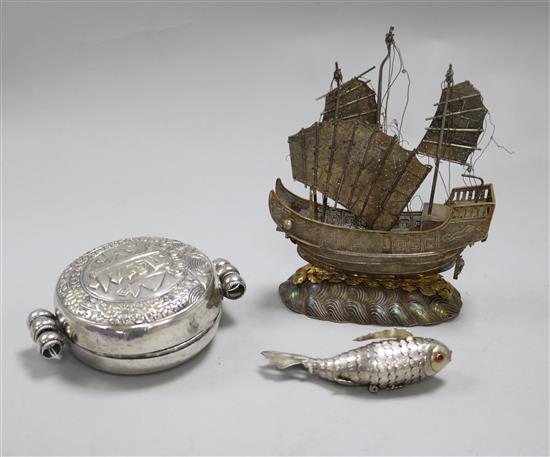 An Indian embossed white metal gau box and two other items